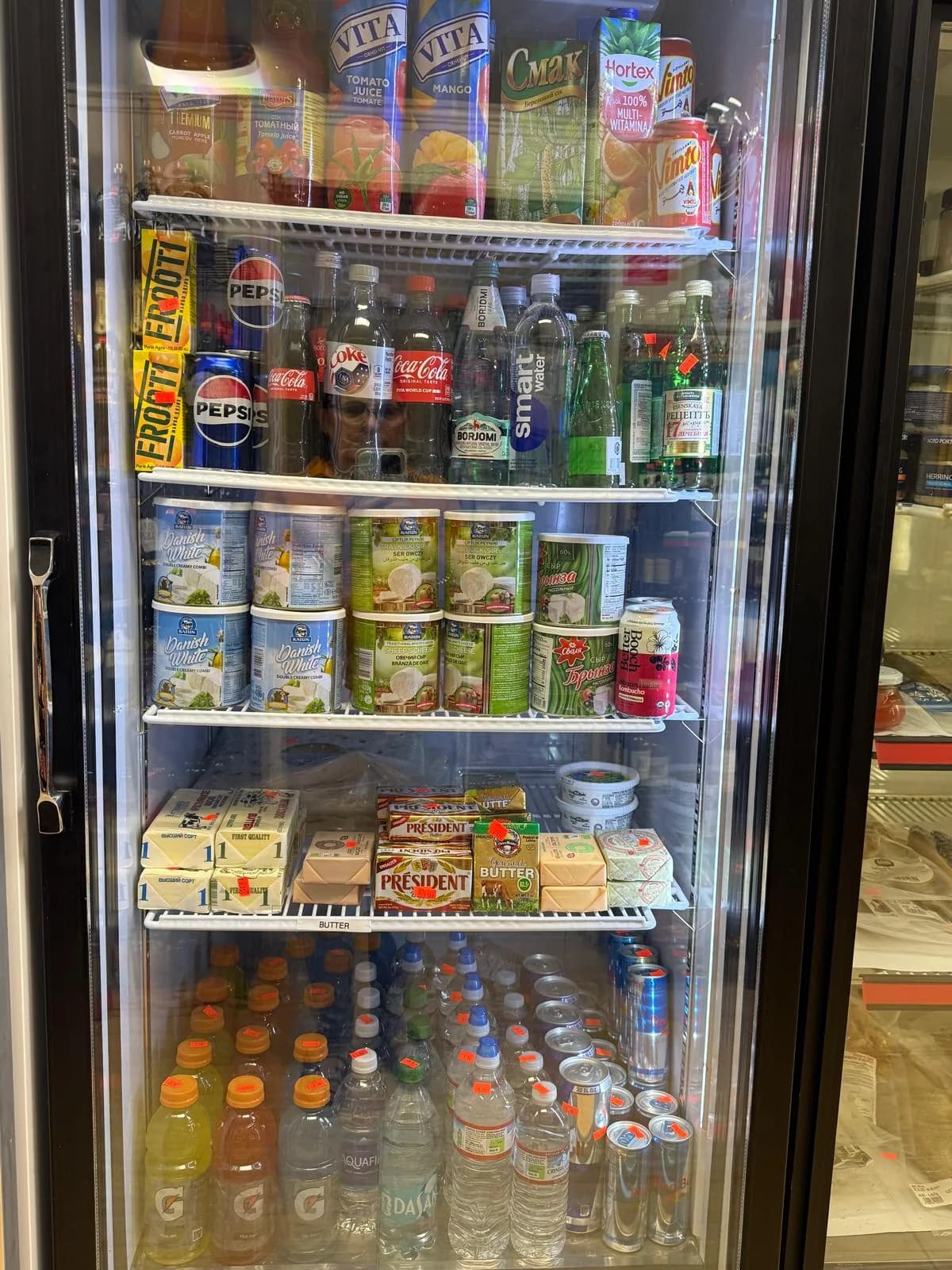 A fridge of European juices, waters, and soft drinks