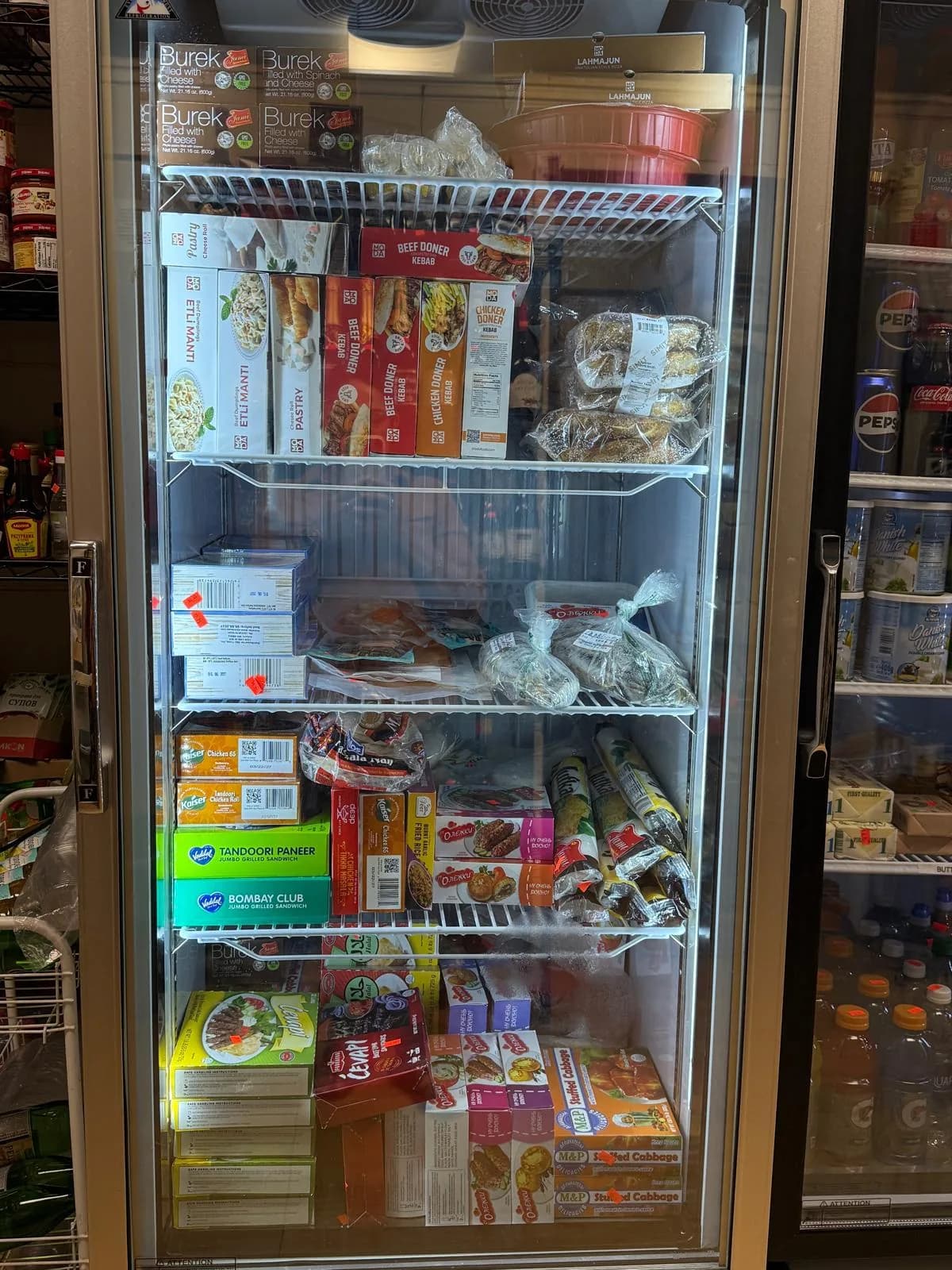 The frozen foods case with dumplings and ready-to-cook classics
