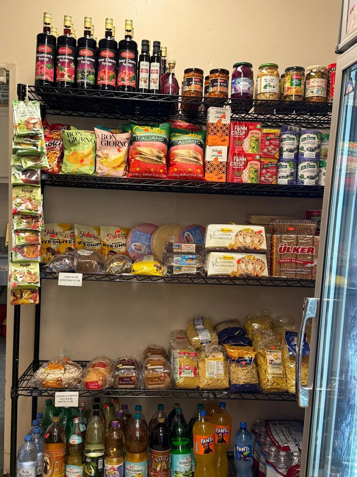 Juices, syrups, and snacks stocked along the aisle
